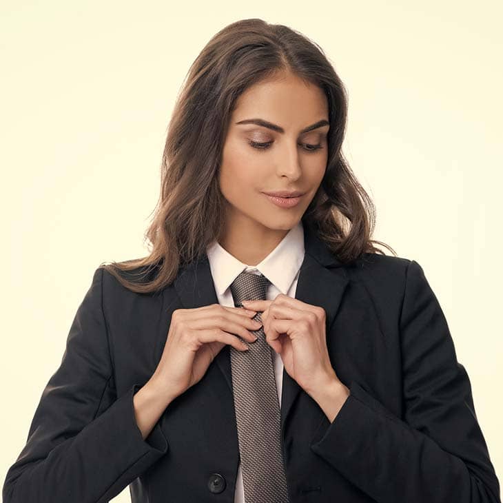 Woman Fixing Tie | What To Wear To Court? 20+ Outfit Ideas And 35+ Fashion Tips Woman fixing tie