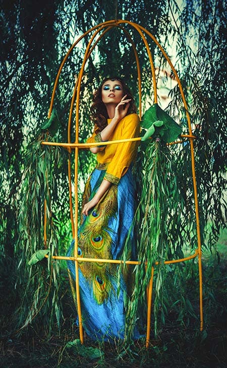 Model posing colorful peacock dress